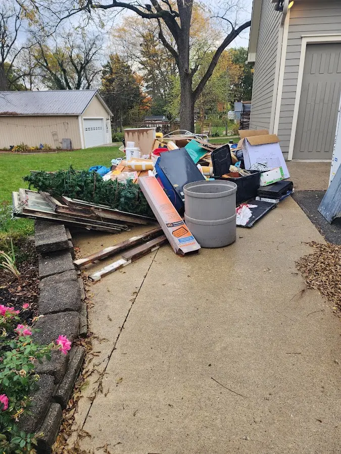 Dumpster being loaded with debris for 30 Yard Dumpster Rental in Denton